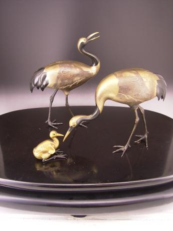 JAPANESE EARLY 20TH CENTURY BRONZE CRANE FAMILY OKIMONO AND STAND<br><font color=red><b>SOLD</b></font>