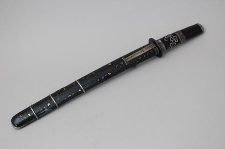 JAPANESE EARLY 20TH CENTURY MINIATURE SWORD WITH SILVER AND LACQUER MOUNT<br><font color=red><b>SOLD</b></font> 