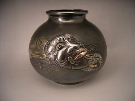 JAPANESE 20TH CENTURY SILVER VASE WITH OKINA NOH MASK DESIGN BY KOUSHUU<br><font color=red><b>SOLD</b></font>